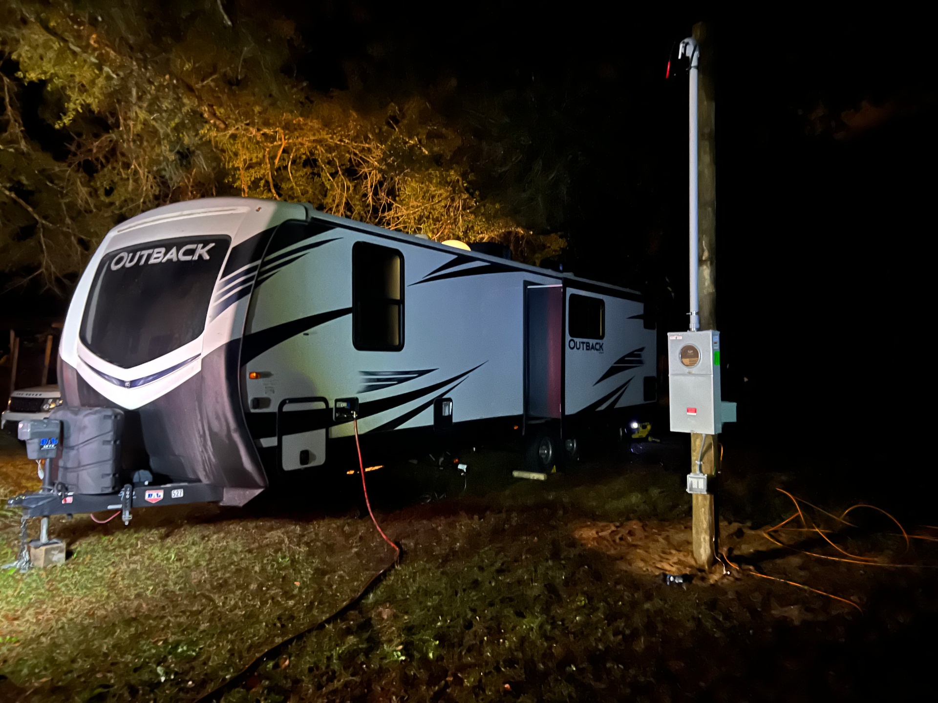 Temporary power pole with utility meter installed on a homeowner's property to supply 50-amp electrical service to a temporary RV housing unit